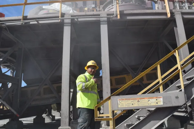 Team member beside processing equipment
