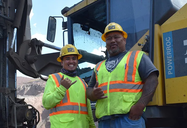 Grace Pacific crew members beside equipment