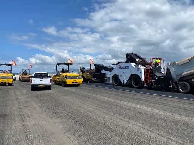 Daytime runway paving equipment